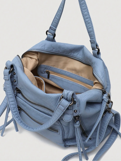 [strip: Practical Inner Pockets | Organization made easy: A zippered inner pocket keeps valuables like keys or cards safe. Two additional inner compartments keep your phone and essentials within reach, without any rummaging.]
